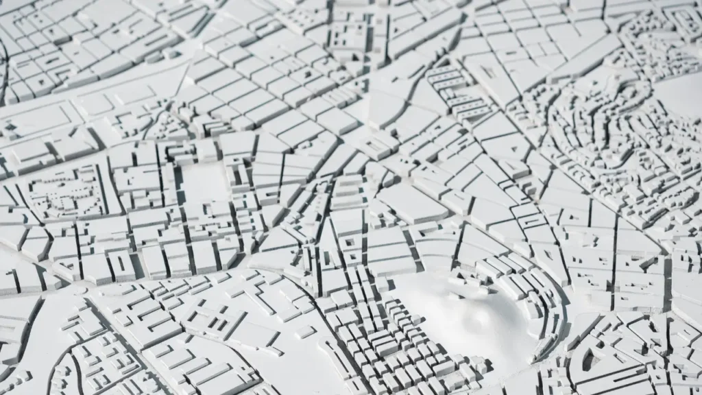 Maquette urbaine en relief représentant les parcelles et quartiers, illustration des données DVF Etalab sur les prix des terrains vendus en 2026.