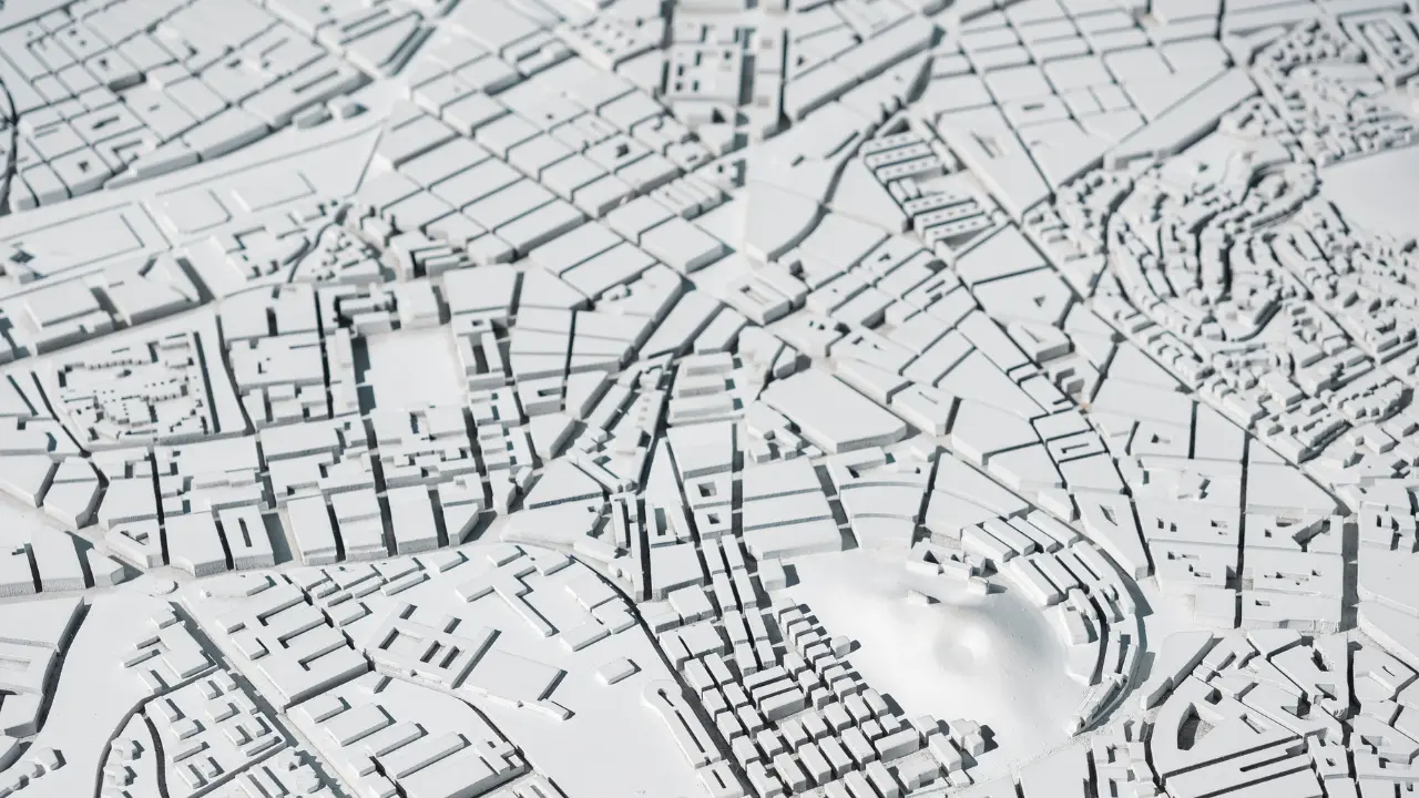 Maquette urbaine en relief représentant les parcelles et quartiers, illustration des données DVF Etalab sur les prix des terrains vendus en 2026.